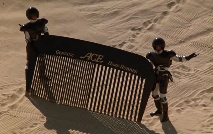 Two soldiers explain to their superior officer that combing the desert hasn't yet yielded results. Summary of current progress